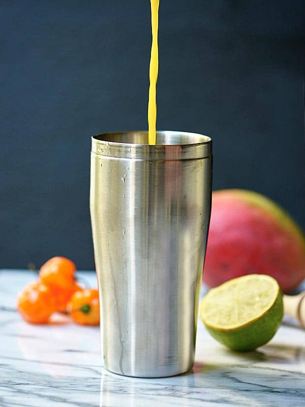 Margarita being poured into drink shaker