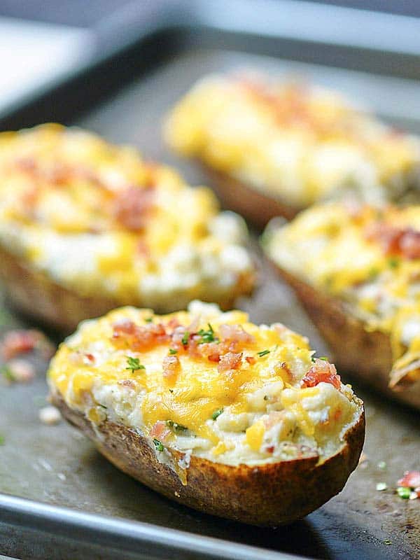 jalapeno popper baked potatoes on baking sheet