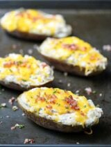 Jalapeno Popper Twice Baked Potatoes - a twice baked potato filled with all of your favorite jalapeño popper ingredients! showmetheyummy.com #jalapeno #jalapenopopper #bakedpotatoes #potatoes #bacon #cheese #spicy #ranch