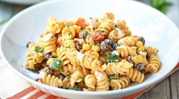 This Mexican Pasta Salad needs to make an appearance at your next grill out. A fun textured pasta + fresh crunchy veggies + black beans + a kick butt sauce! showmetheyummy.com #mexicanfood #pasta #salad #mexicanpastasalad #pastasalad #grilling #sidedish #vegetarian