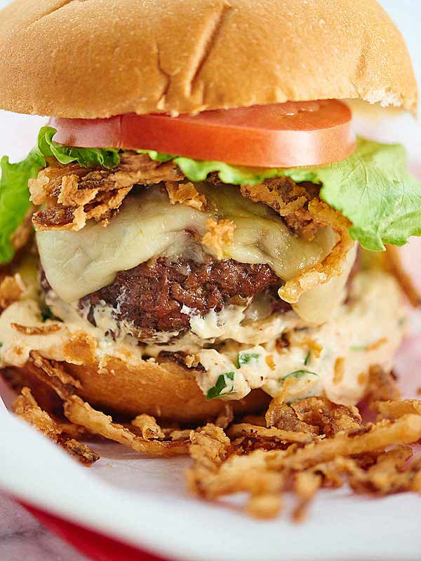 closeup of pepper jack stuffed burger with jalapeno cream sauce