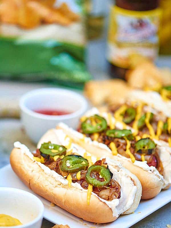 Three seattle hot dogs lined on plate