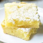 Summer Shandy Lemon Bars! The base is a simple shortbread crust. It’s rich, buttery, and perfectly sweet. The filling is a twist on a classic. It’s light, lemony, and the Summer Shandy comes through beautifully. showmetheyummy.com #summer #shandy #beer #lemon #lemonbars #dessert #shortbread #summershandy