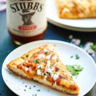This Grilled BBQ Chicken Pizza is the perfect Friday night, summer treat! Homemade dough, spicy BBQ crockpot chicken, gooey cheese, and fresh red onions and cilantro make this the best! showmetheyummy.com #pizza #bbq