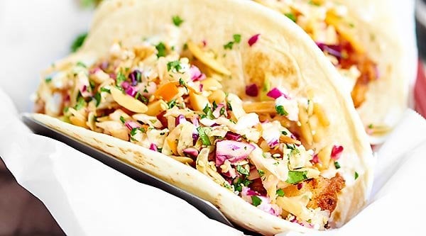 Beer Battered Fish Tacos w/ Asian Slaw. Flour tortillas stuffed with crispy, golden, tender, beer battered cod and topped with toasty, crunchy, fresh coleslaw! showmetheyummy.com #seafood #tacos