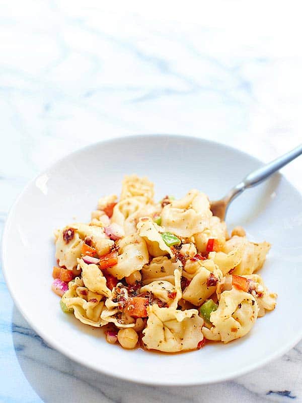 This Greek Tortellini Pasta Salad is vegetarian, easy, and so tasty! Sun dried tomatoes. Salty feta. Chickpeas. Fresh vegetables. Cheese Pasta. Yes please! showmetheyummy.com #pasta #vegetarian