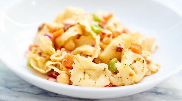 This Greek Tortellini Pasta Salad is vegetarian, easy, and so tasty! Sun dried tomatoes. Salty feta. Chickpeas. Fresh vegetables. Cheese Pasta. Yes please! showmetheyummy.com #pasta #vegetarian