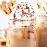 This S’Mores Iced Coffee is creamy, chocolatey, filled with marshmallow fluff and has a fun chocolate and graham cracker rim! It’s a caffeinated S’Mores in a glass! showmetheyummy.com #smores #chocolate #coffee #dessert #breakfast #marshmallow