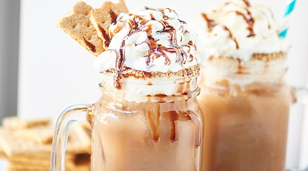 This S’Mores Iced Coffee is creamy, chocolatey, filled with marshmallow fluff and has a fun chocolate and graham cracker rim! It’s a caffeinated S’Mores in a glass! showmetheyummy.com #smores #chocolate #coffee #dessert #breakfast #marshmallow