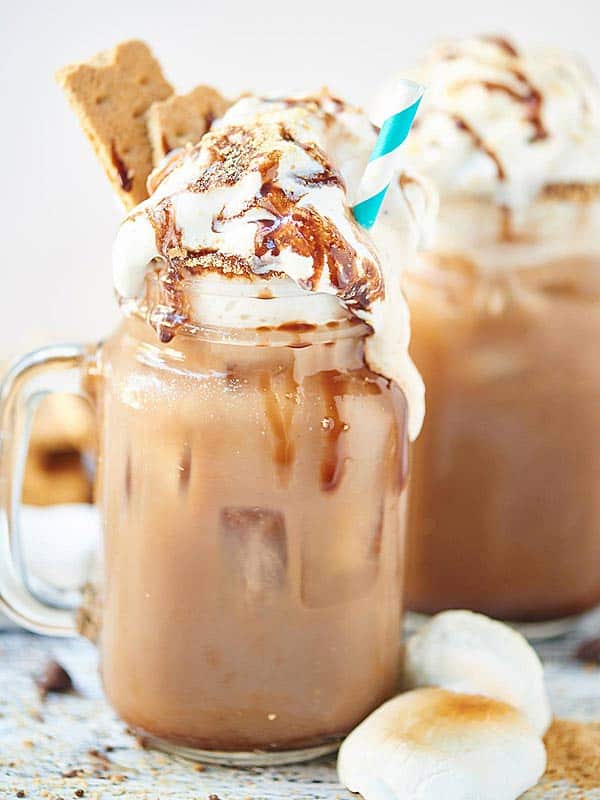 s'mores iced coffee in mason jar with whipped cream and straw