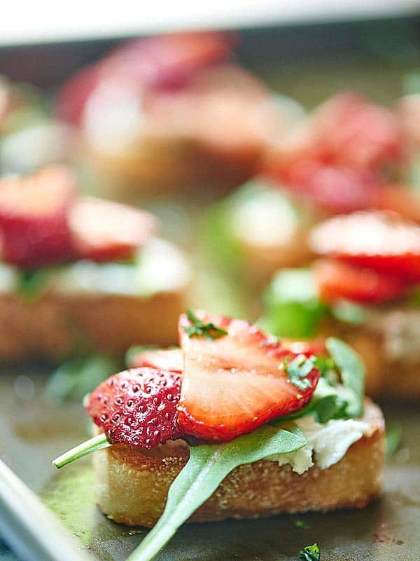 strawberry goat cheese bruschetta on baking sheet