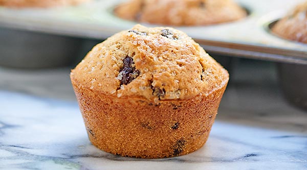 Looking for moist, jumbo, bakery style muffins? Good! These Chocolate Chip Muffins are for you! They're easy to make and there's chocolate in every bite. showmetheyummy.com #breakfast #muffin