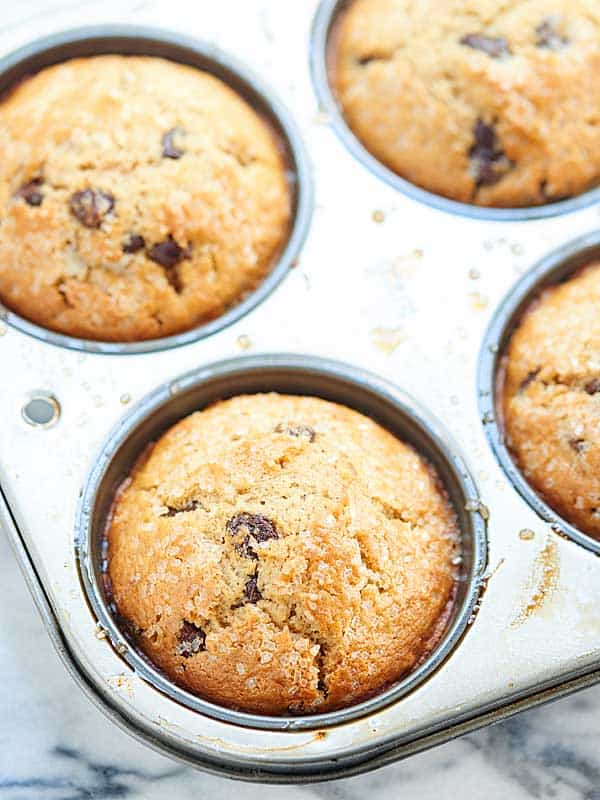 chocolate chip muffins in muffin tin above