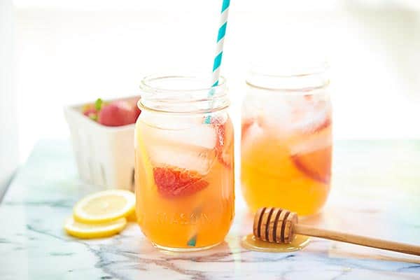 This honey strawberry lemonade only has four ingredients and is naturally sweetened! Perfect for kids! Add a shot of gin for an adults only cocktail! showmetheyummy.com #honey #lemonade