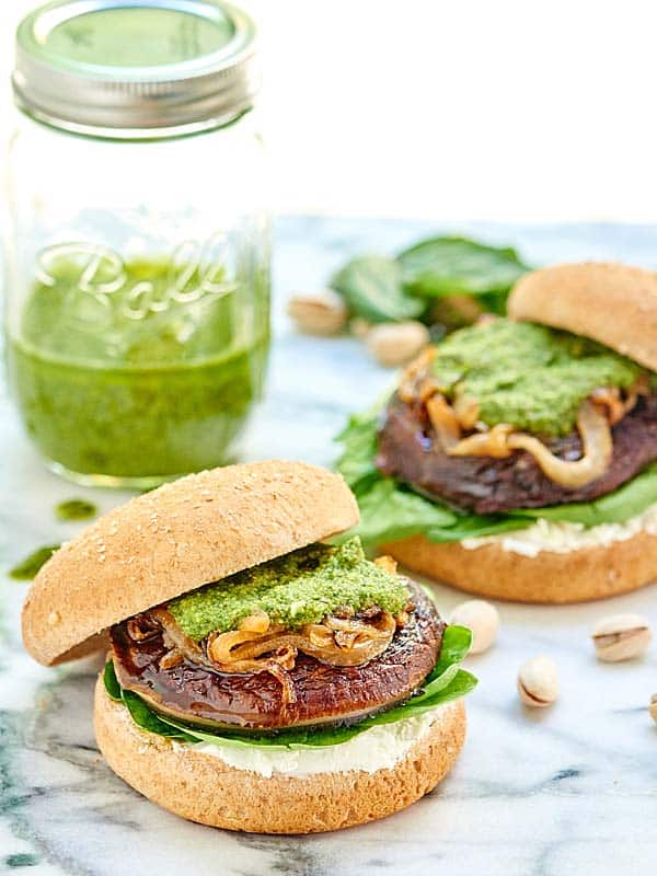 This Portobello Mushroom Burger is vegetarian, healthy, can be gluten free, and is topped with caramelized onions, a homemade basil pesto, and goat cheese! showmetheyummy.com #vegetarian #burger