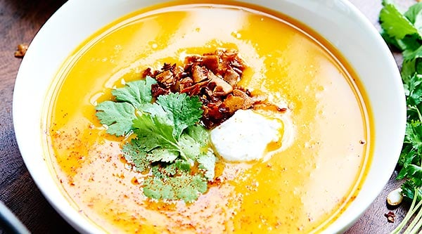 This Crockpot Butternut Squash Soup Recipe is vegan, gluten free, healthy, full of vegetables, and topped with coconut cream, cilantro, and coconut bacon! showmetheyummy.com #vegan #soup