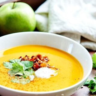 This Crockpot Butternut Squash Soup Recipe is vegan, gluten free, healthy, full of vegetables, and topped with coconut cream, cilantro, and coconut bacon! showmetheyummy.com #vegan #soup