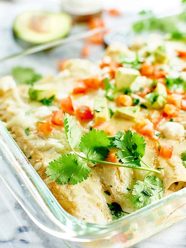 green chile chicken enchiladas in baking dish