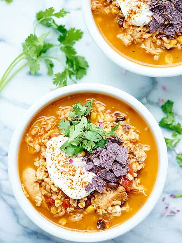 Two bowls of Mexican chicken and rice soup above