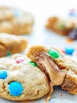 These Peanut Butter Salted Caramel Cookies are made of a simple peanut butter dough, studded with M&Ms, white chocolate chips, and salty pretzels. To make these even more decadent, they get stuffed with rolos! showmetheyummy.com #dessert #cookies