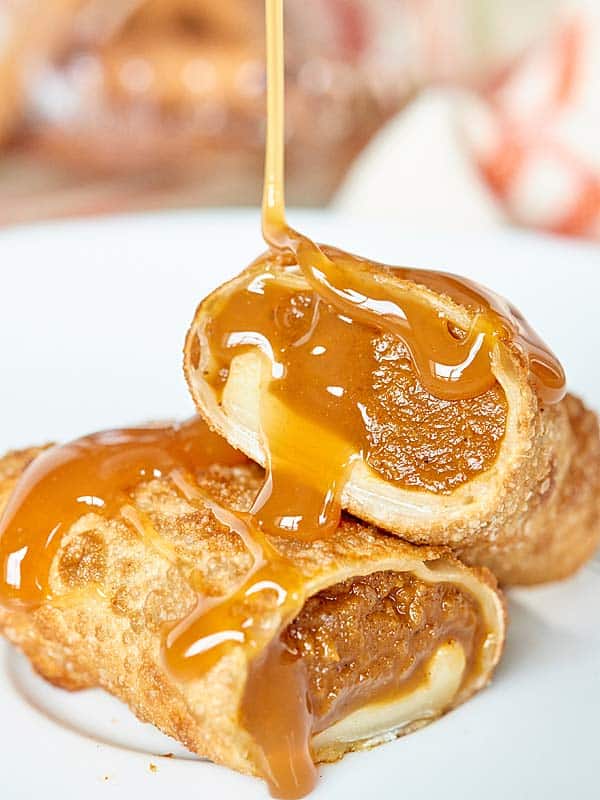 two halves egg roll being drizzled with caramel