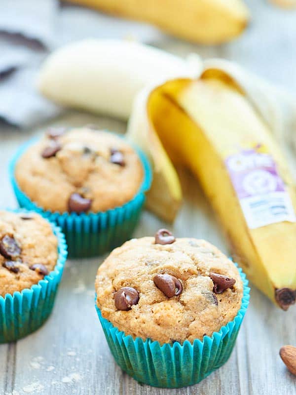 vegan banana chocolate chip muffins next to half peeled banana