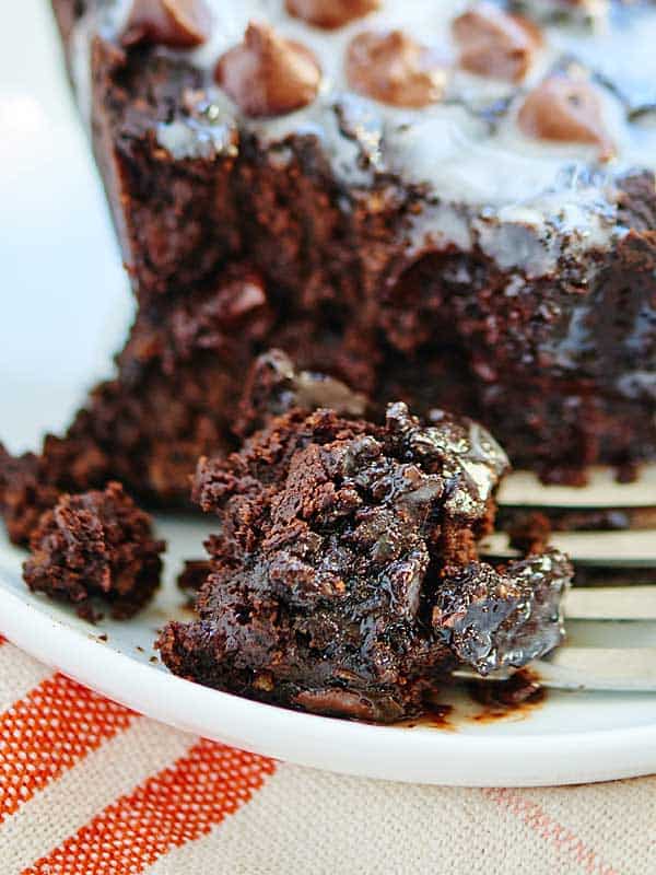 Bite of brownie being taken out of whole with a fork