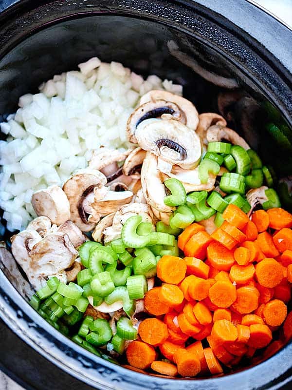 onions, mushroom, celery, and carrots in crockpot