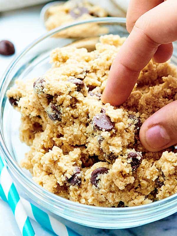 edible cookie dough being grabbed out of bowl