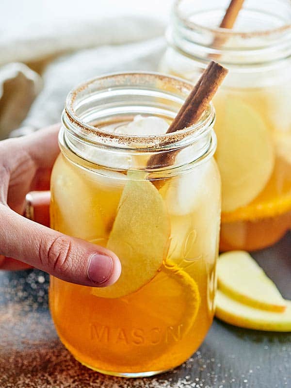 jar of fall sangria being lifted off counter