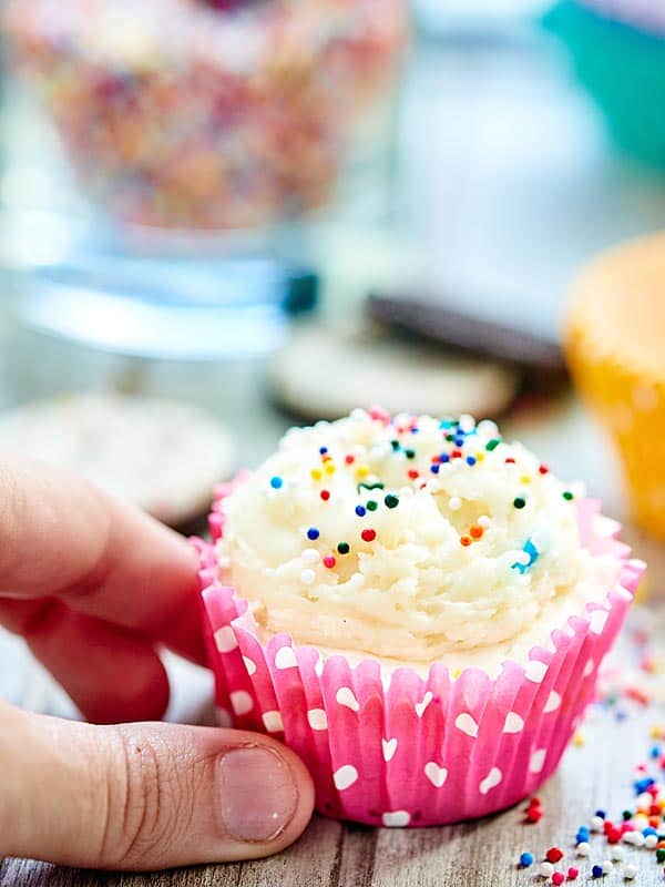 funfetti cheesecake cupcake being picked up