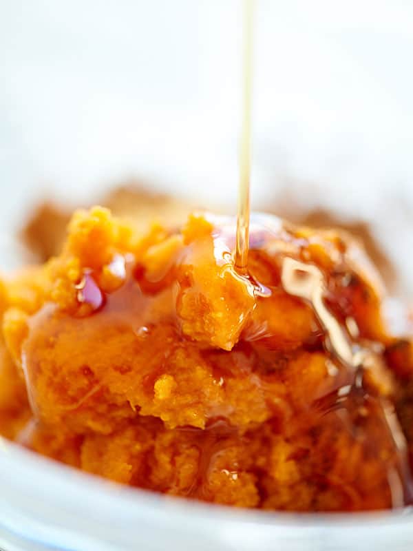pumpkin puree being drizzled with maple syrup