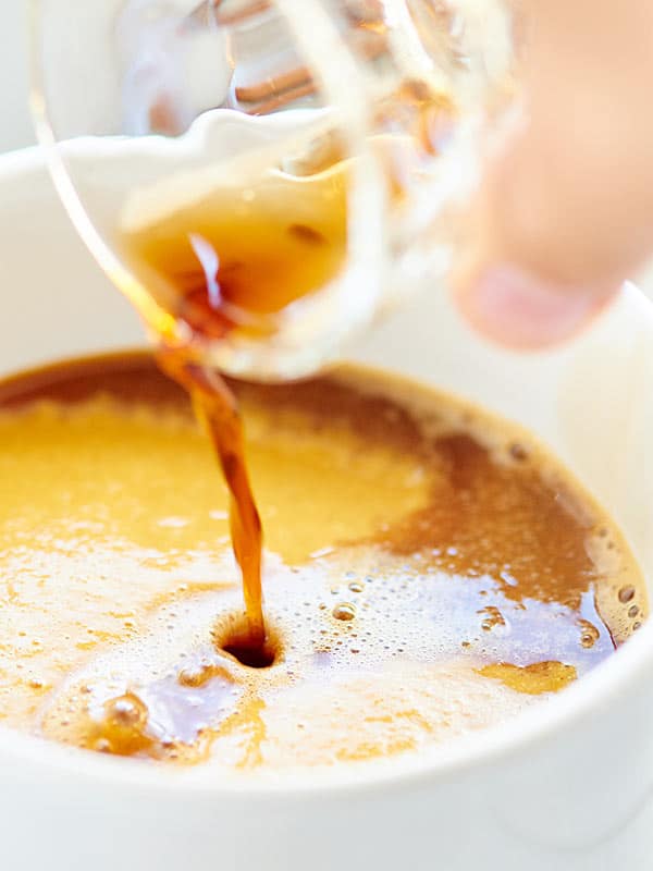 espresso being poured into mug 