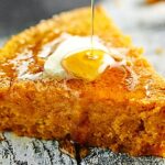 This pumpkin cornbread is a great, easy, vegan side dish for any meal! It's made with whole wheat pastry flour, coconut oil, and smothered in maple syrup! showmetheyummy.com #vegan #pumpkin