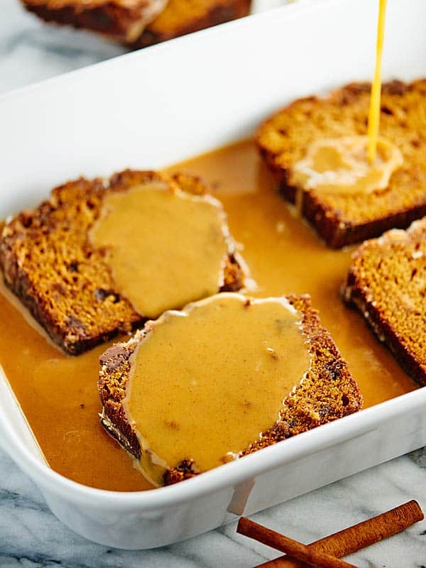 slices of pumpkin bread in baking dish with egg mixture