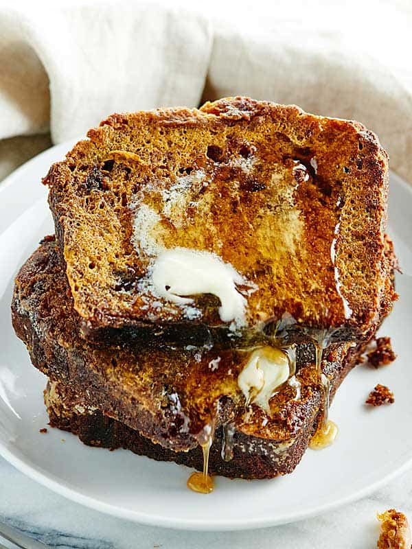 3 pieces of pumpkin french toast stacked on plate