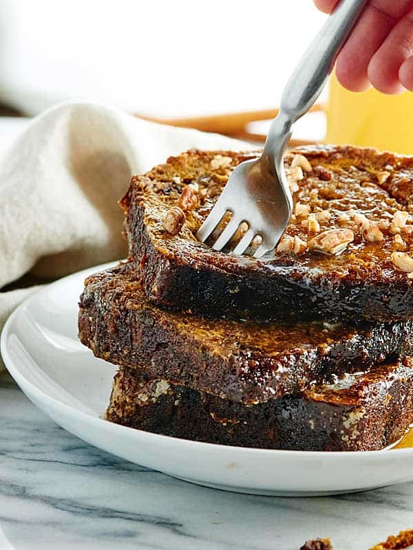 fork being put into stack of 3 pieces of toast