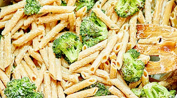 This Vegan Alfredo with Broccoli is made with a healthy cauliflower sauce, roasted broccoli, and whole wheat penne pasta! Cozy, healthy food at it's finest! showmetheyummy.com #pasta #vegan