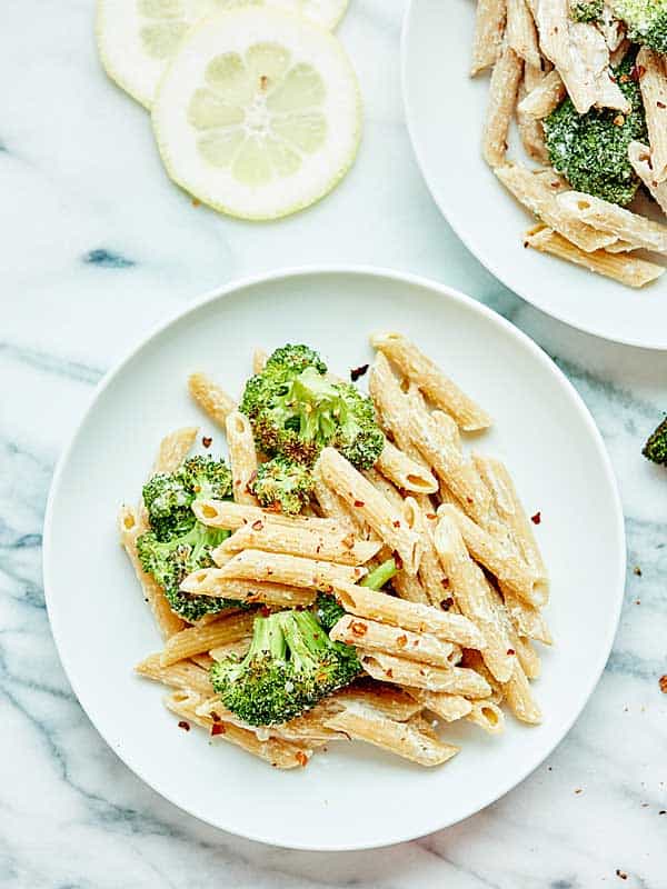 plate of vegan alfredo with broccoli above