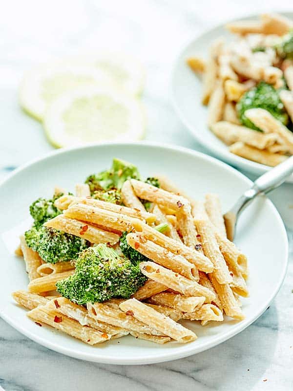 plate of vegan alfredo with broccoli side view