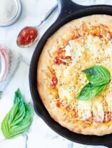 This Easy Cheese Pizza Recipe is made in a skillet, smothered in a homemade tomato sauce, and topped with four cheeses: brie, gruyere, asiago, and ricotta! showmetheyummy.com #cheese #pizza