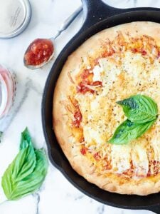 This Easy Cheese Pizza Recipe is made in a skillet, smothered in a homemade tomato sauce, and topped with four cheeses: brie, gruyere, asiago, and ricotta! showmetheyummy.com #cheese #pizza