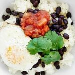 This Cheesy Rice and Beans Recipe is an easy vegetarian, gluten free breakfast or dinner! Black beans & fried eggs makes this dish full of protein! showmetheyummy.com #breakfast #vegetarian