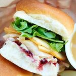This Leftover Turkey Sandwich Recipe is made with leftover rolls, shredded turkey, gravy, gouda cheese, raspberry jam, and arugula! It's great hot or cold! showmetheyummy.com #thanksgiving #leftovers