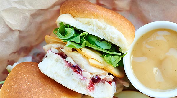 This Leftover Turkey Sandwich Recipe is made with leftover rolls, shredded turkey, gravy, gouda cheese, raspberry jam, and arugula! It's great hot or cold! showmetheyummy.com #thanksgiving #leftovers
