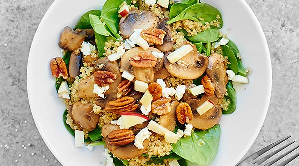 This Warm Mushroom Quinoa Salad is full of mushrooms and quinoa, spinach, goat cheese, pecans, and is smothered in a honey and apple cider vinegar dressing! showmetheyummy.com #quinoa #salad