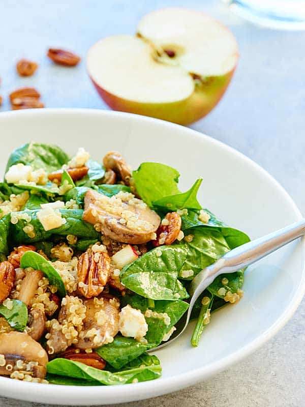 quinoa salad on plate, half apple in background