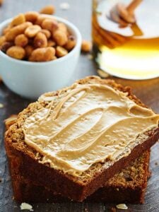 This Peanut Butter Honey Banana Bread recipe is moist, peanut butter-y, naturally sweetened w/ honey & bananas, & topped w/ a honey roasted peanut streusel. showmetheyummy.com #bananabread #baking