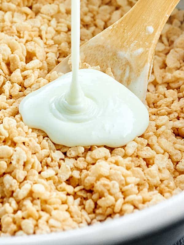 Melted marshmallow being poured into rice krispie cereal