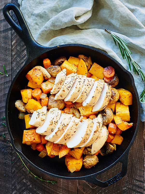 roasted chicken and vegetables in skillet above